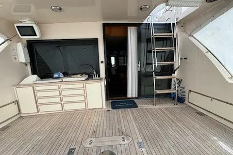 Slide: The Image of 1993 Mikelson 50 Sportfisher yacht interior with wooden deck and ladder. - 20