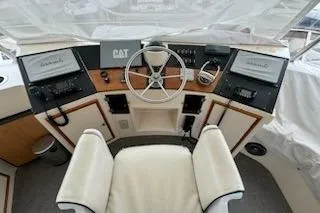 Slide: The Image of Cockpit of 1993 Mikelson 50 Sportfisher with steering wheel and navigation equipment. - 21