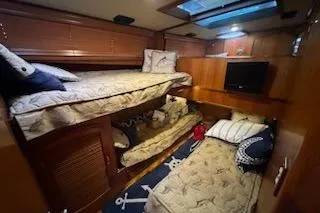 Slide: The Image of Cozy cabin interior of 1993 Mikelson 50 Sportfisher with bunk beds and nautical decor. - 7