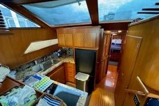 Slide: The Image of Interior of 1993 Mikelson 50 Sportfisher yacht with wooden cabinetry and modern kitchen amenities. - 8