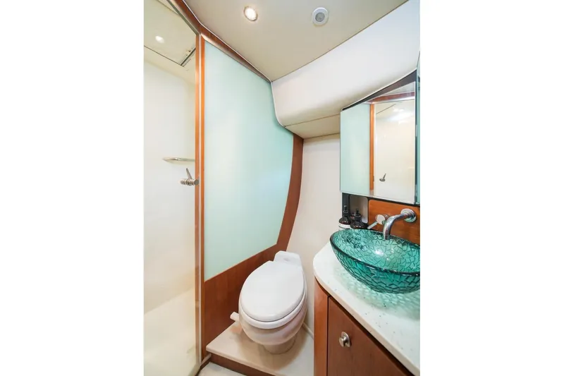 Slide: The Image of Luxurious bathroom in 2006 Tiara Yachts 4300 Sovran with glass sink and modern fixtures. - 17