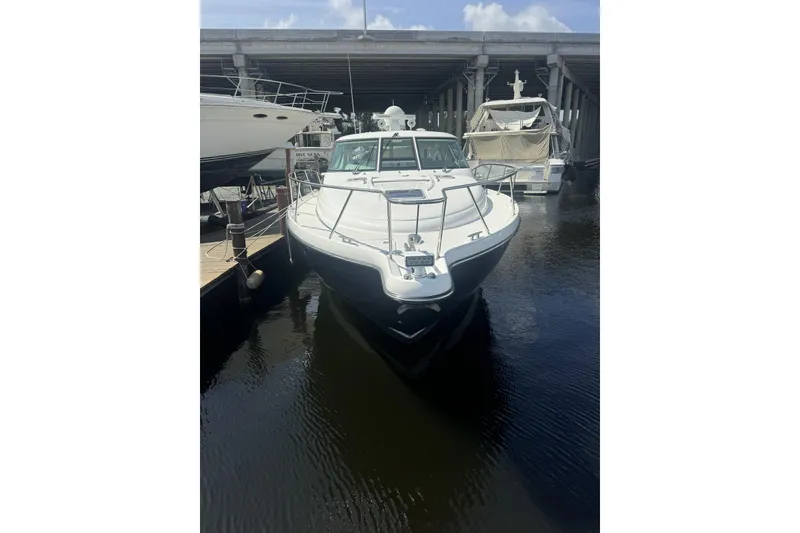Slide: The Image of 2006 Tiara Yachts 4300 Sovran docked under a bridge on a sunny day. - 3
