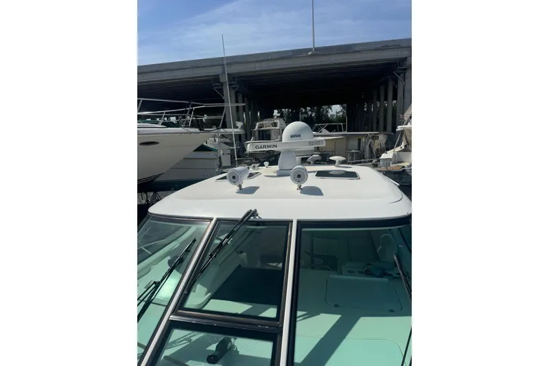 Slide: The Image of 2006 Tiara Yachts 4300 Sovran with Garmin radar, docked under a bridge. - 5