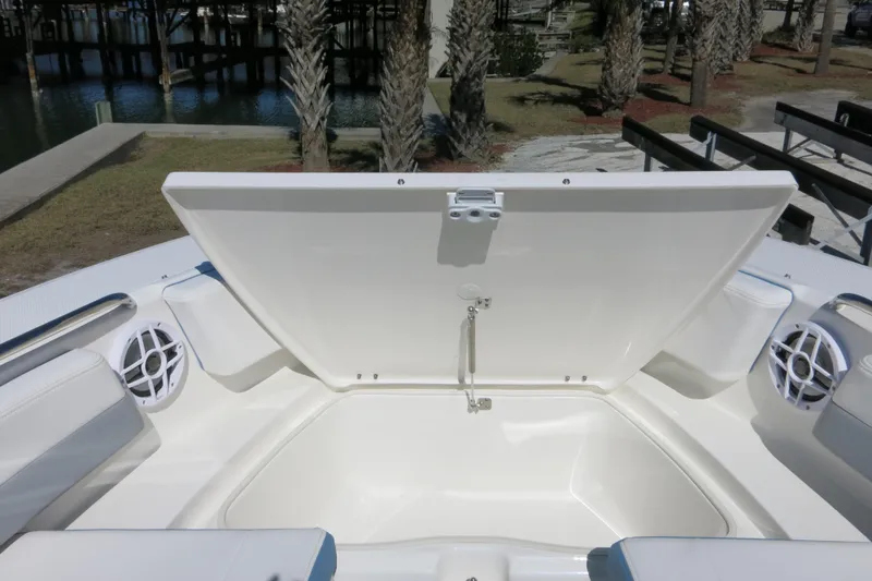 Slide: The Image of 2026 Robalo R207 Dual Console boat with open storage compartment and speakers. - 11