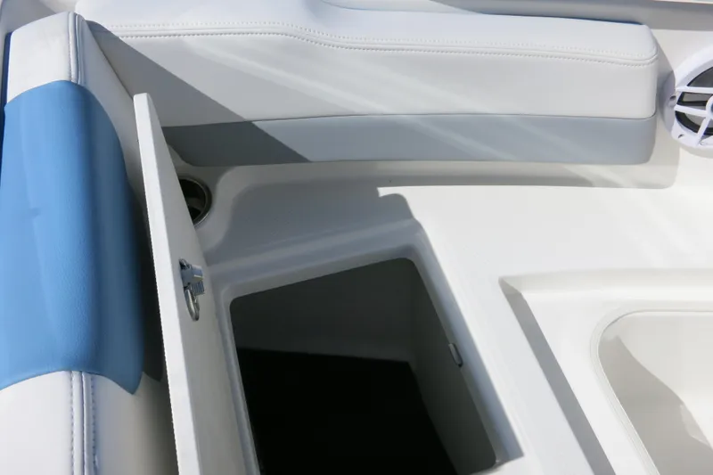 Slide: The Image of 2026 Robalo R207 Dual Console interior storage compartment with blue and white seating. - 13