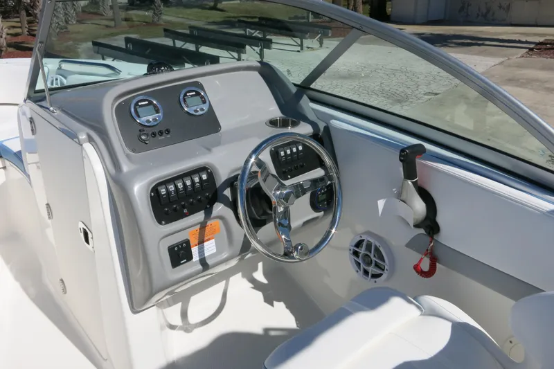 Slide: The Image of 2026 Robalo R207 Dual Console boat dashboard with steering wheel and control panel. - 15