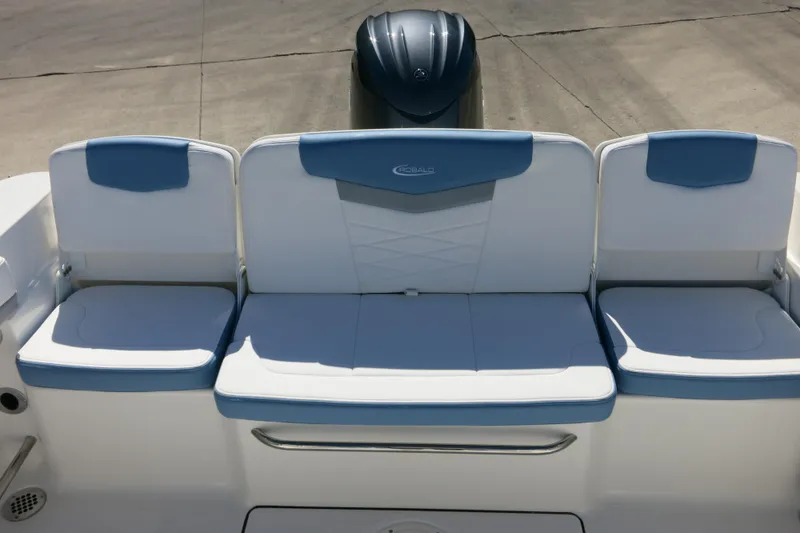 Slide: The Image of 2026 Robalo R207 Dual Console boat seating with blue and white cushions. - 19