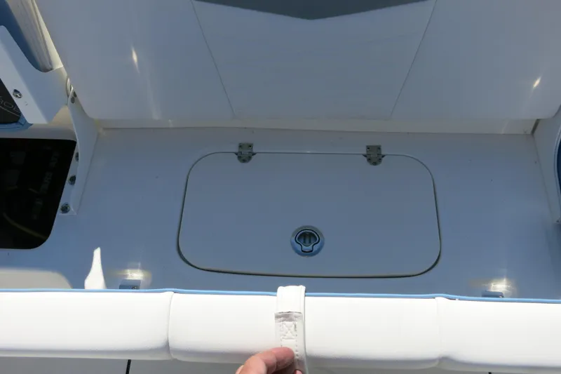 Slide: The Image of 2026 Robalo R207 Dual Console boat deck with storage compartment. - 21