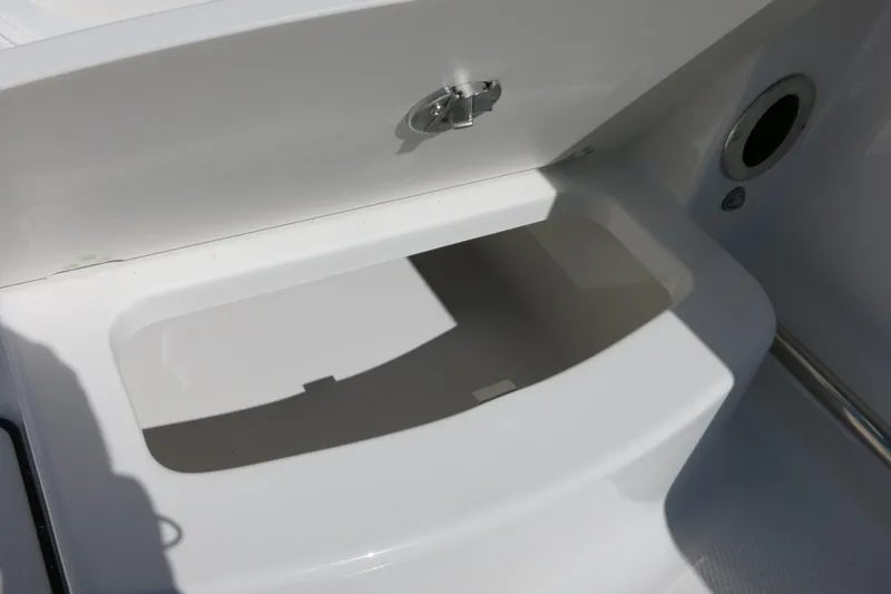 Slide: The Image of Storage compartment on a 2026 Robalo R207 Dual Console boat. - 23