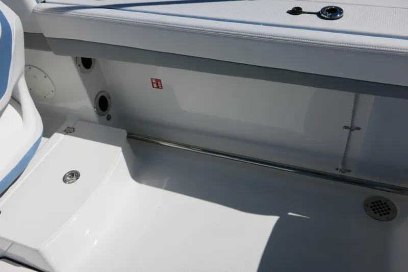 Slide: The Image of 2026 Robalo R207 Dual Console boat interior, featuring sleek seating and storage area. - 26