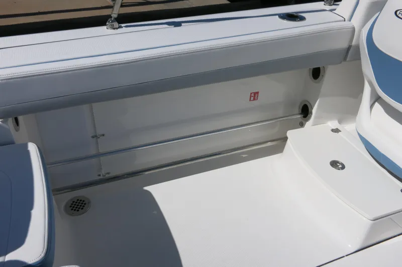 Slide: The Image of 2026 Robalo R207 Dual Console boat interior with white seating and stainless steel accents. - 27