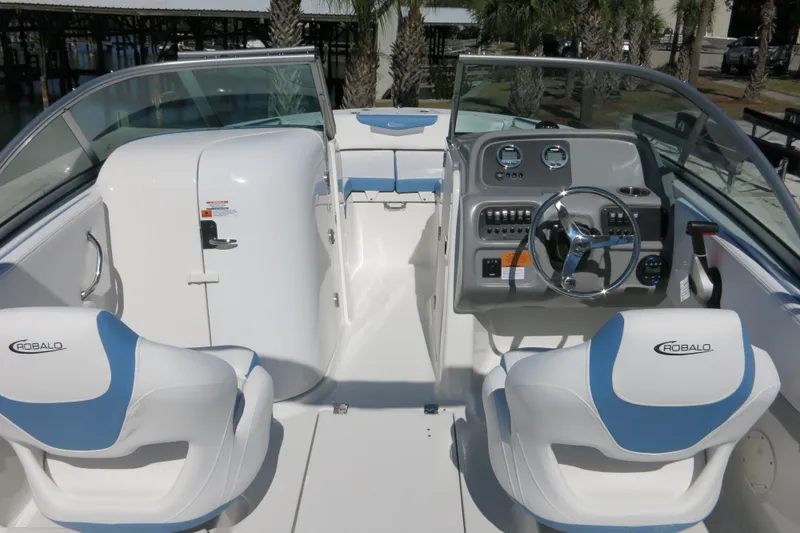 Slide: The Image of 2026 Robalo R207 Dual Console boat interior with steering wheel and seating. - 28