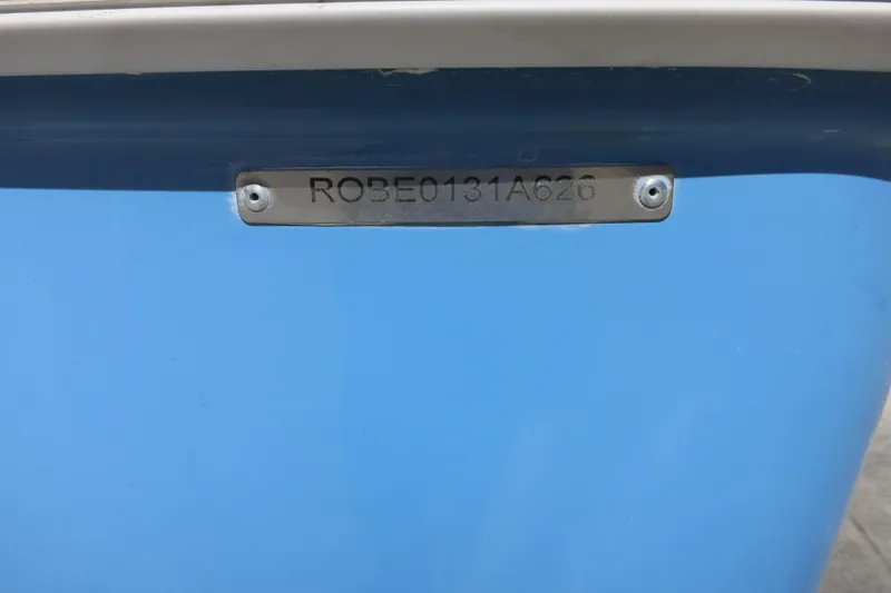 Slide: The Image of 2026 Robalo R207 Dual Console boat hull identification number on blue surface. - 30