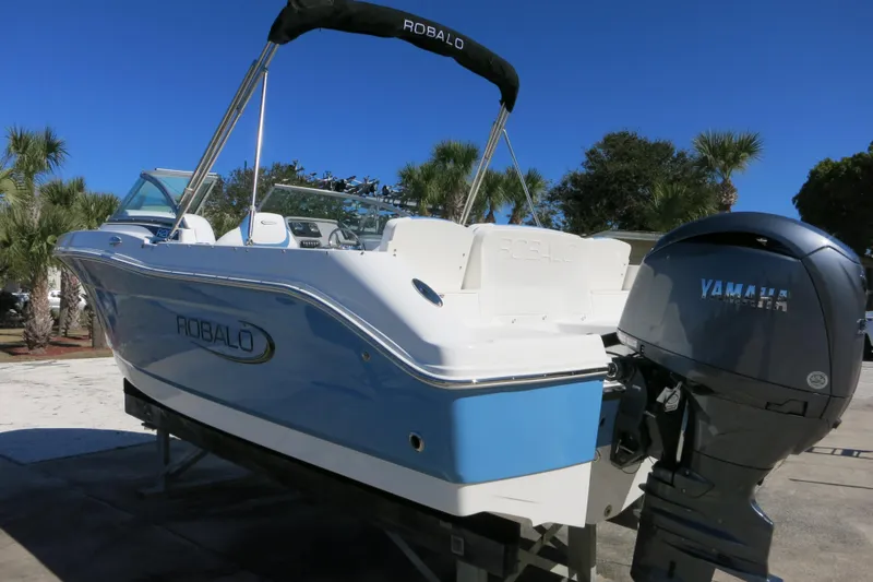 Slide: The Image of 2026 Robalo R207 Dual Console boat with Yamaha engine, parked outdoors. - 4