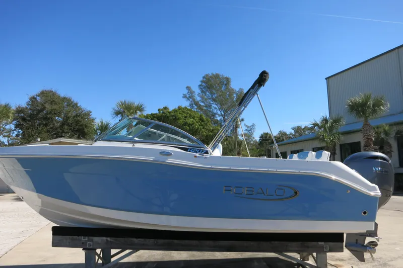 Slide: The Image of 2026 Robalo R207 Dual Console boat on display, featuring sleek design and blue exterior. - 5