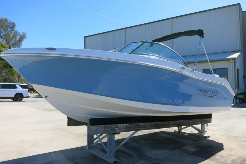Slide: The Image of 2026 Robalo R207 Dual Console boat on display, featuring sleek blue and white design. - 6