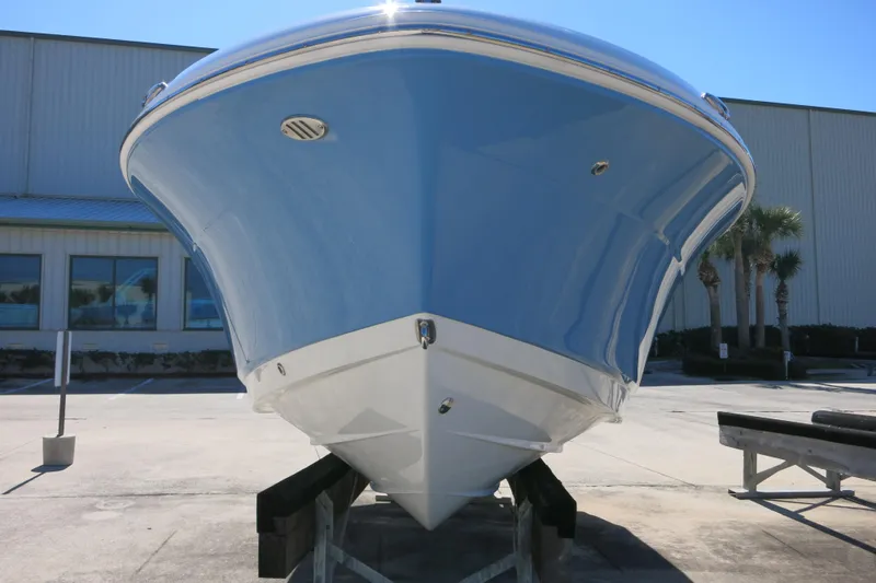 Slide: The Image of 2026 Robalo R207 Dual Console boat on display, showcasing sleek hull design. - 7