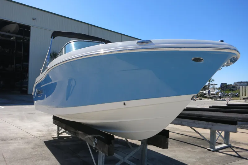 Slide: The Image of 2026 Robalo R207 Dual Console boat on display in a marina setting. - 8