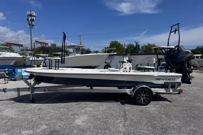 Slide: The Image of 2026 Spyder FX19 Vapor boat on trailer in sunny outdoor setting. - 2