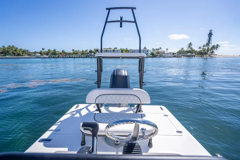 Slide: The Image of 2026 Spyder FX19 Vapor boat on calm water near a lighthouse and palm trees. - 21