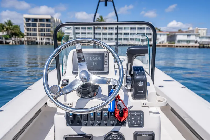 Slide: The Image of Steering console of 2026 Spyder FX19 Vapor boat on water, featuring modern controls. - 26
