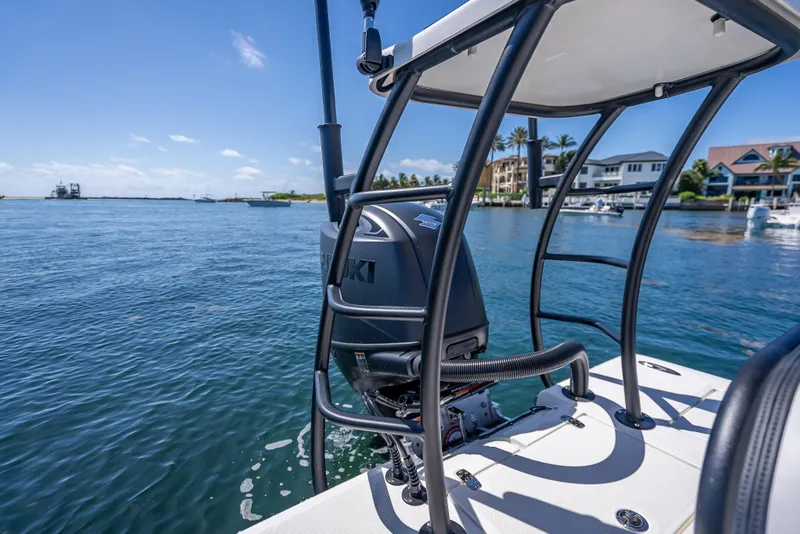 Slide: The Image of 2026 Spyder FX19 Vapor boat on water, featuring Suzuki outboard motor, coastal backdrop. - 31