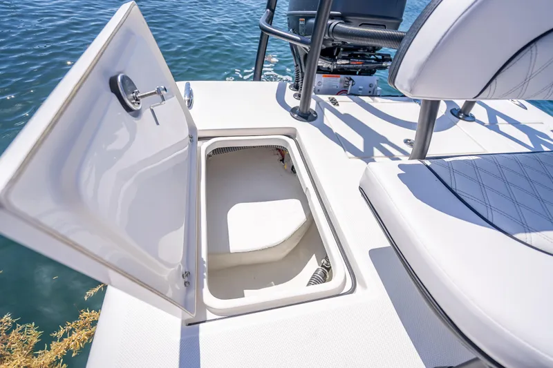 Slide: The Image of Open storage compartment on 2026 Spyder FX19 Vapor boat, near water. - 32