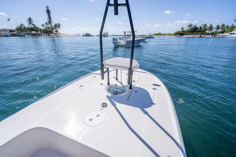 Slide: The Image of 2026 Spyder FX19 Vapor boat on clear blue water near a lighthouse and palm trees. - 34