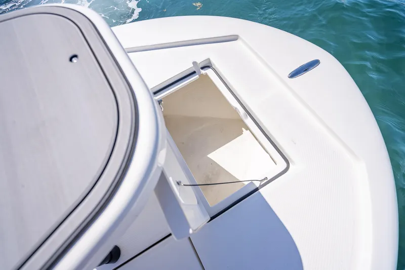 Slide: The Image of Open storage compartment on 2026 Spyder FX19 Vapor boat deck. - 36