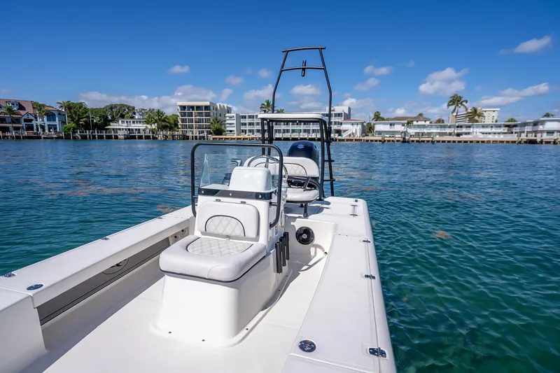 Slide: The Image of 2026 Spyder FX19 Vapor boat on calm water with scenic waterfront view. - 39