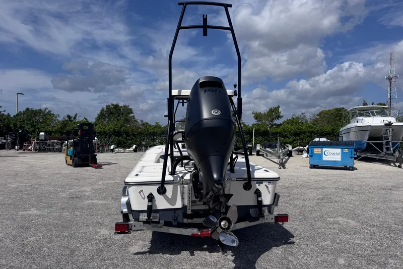 Slide: The Image of 2026 Spyder FX19 Vapor boat with outboard motor in a marina setting. - 4