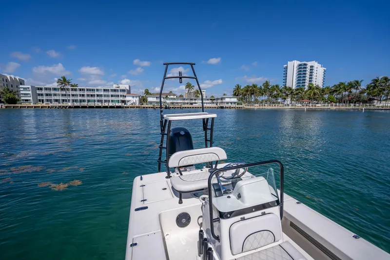 Slide: The Image of 2026 Spyder FX19 Vapor boat on calm water with cityscape and palm trees in background. - 40