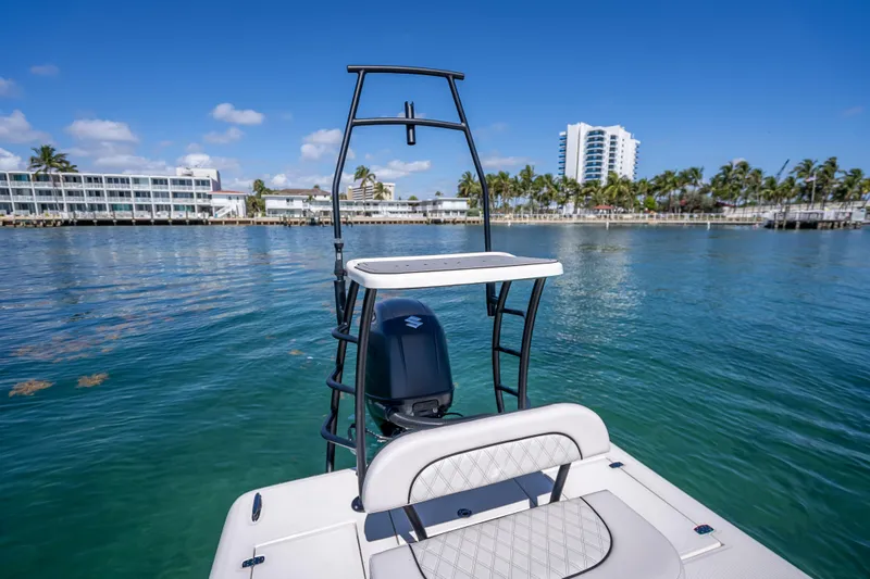 Slide: The Image of 2026 Spyder FX19 Vapor boat on clear water with coastal buildings in background. - 41