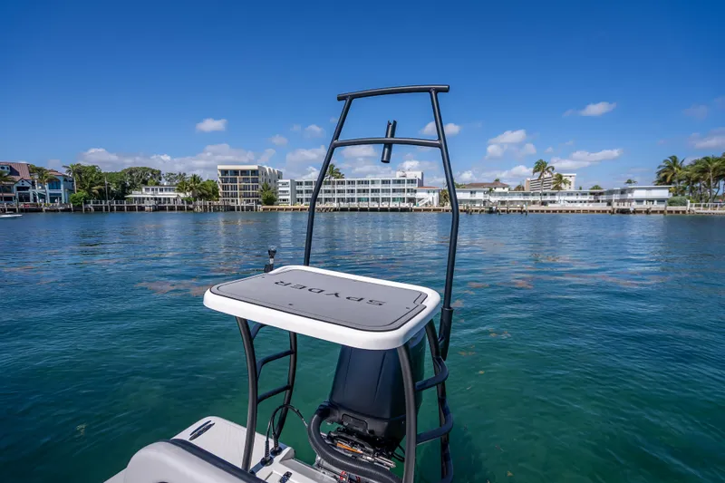 Slide: The Image of 2026 Spyder FX19 Vapor boat on calm water with coastal buildings in the background. - 42