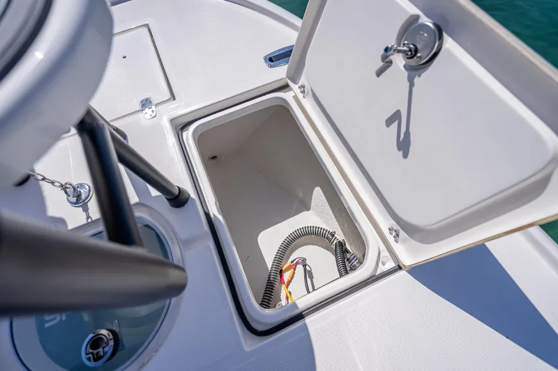 Slide: The Image of Open storage compartment on 2026 Spyder FX19 Vapor boat deck. - 43