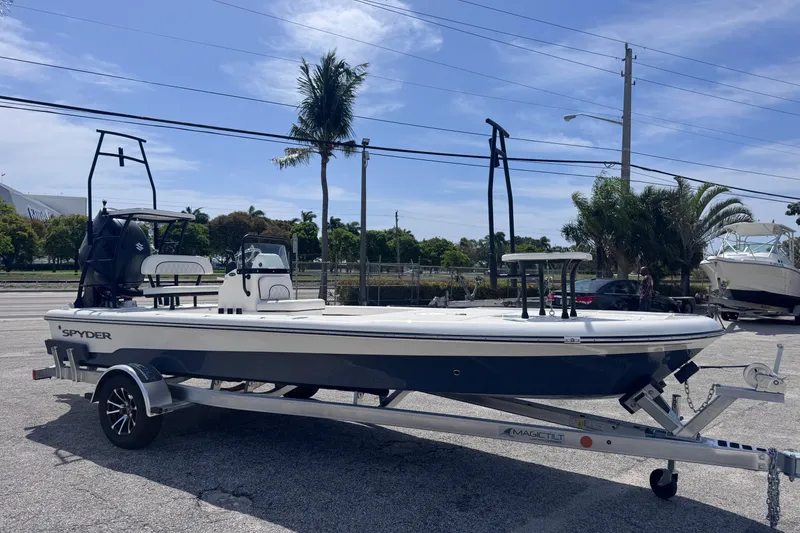 Slide: The Image of 2026 Spyder FX19 Vapor boat on trailer, parked outdoors under clear sky. - 5