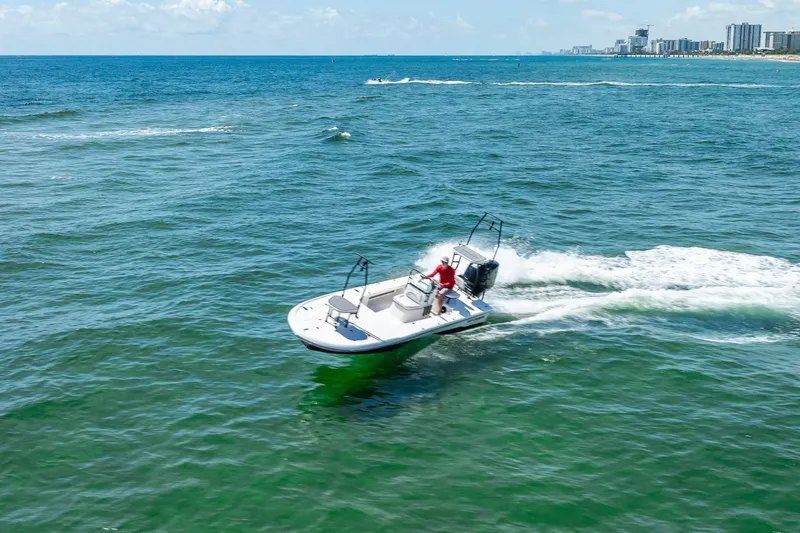 Slide: The Image of 2026 Spyder FX19 Vapor boat on trailer, parked outdoors under clear sky. - 54