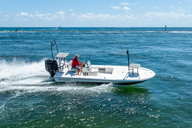 Slide: The Image of 2026 Spyder FX19 Vapor boat on trailer, parked outdoors under clear sky. - 55