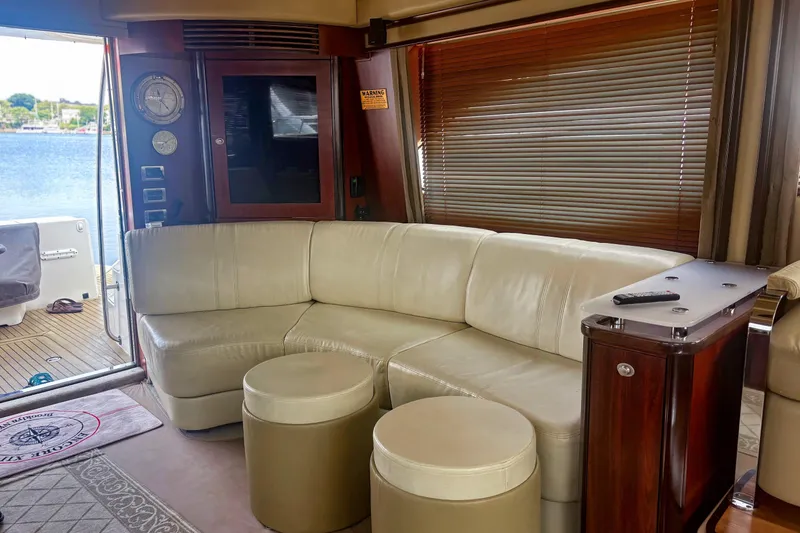 Slide: The Image of Luxurious interior of 2006 Sea Ray 52 Sedan Bridge yacht with leather seating and wooden accents. - 24