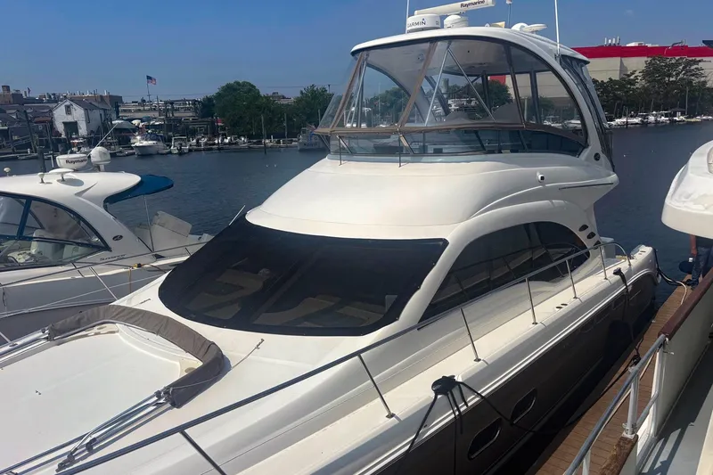 Slide: The Image of 2006 Sea Ray 52 Sedan Bridge yacht docked at marina, sunny day, waterfront view. - 6