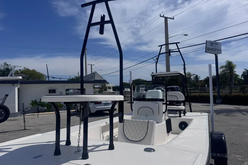 Slide: The Image of 2026 Spyder FX17 Flicker boat with elevated seating, parked outdoors under a clear sky. - 13