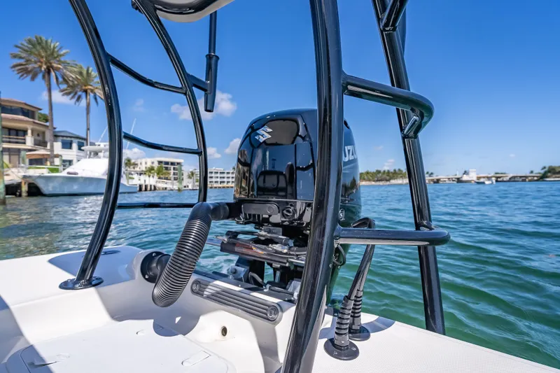 Slide: The Image of 2026 Spyder FX17 Flicker boat with Suzuki outboard motor on a sunny waterfront. - 21