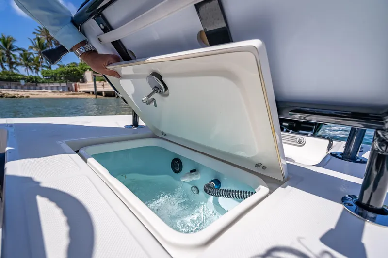 Slide: The Image of Livewell compartment on 2026 Spyder FX17 Flicker boat, open with water inside. - 22