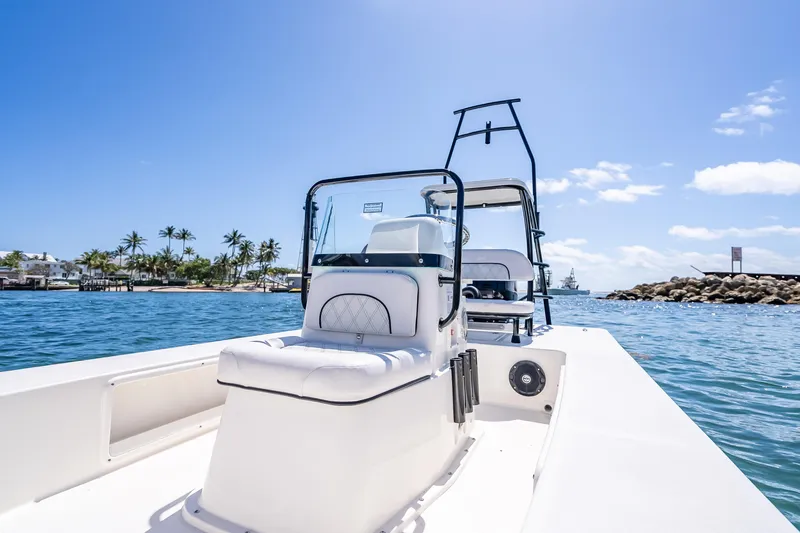 Slide: The Image of 2026 Spyder FX17 Flicker boat on clear blue water, sunny day, palm trees in background. - 28