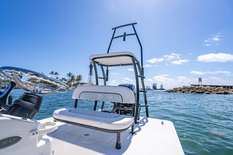Slide: The Image of 2026 Spyder FX17 Flicker boat on sunny ocean with lighthouse and palm trees. - 29