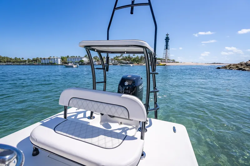 Slide: The Image of 2026 Spyder FX17 Flicker boat on clear blue water near a lighthouse. - 33