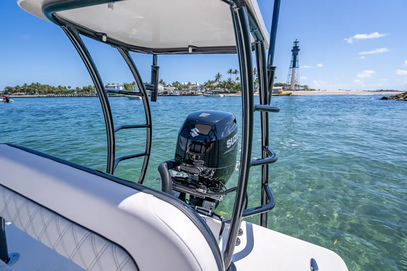 Slide: The Image of 2026 Spyder FX17 Flicker boat with Suzuki engine on clear water near a lighthouse. - 35