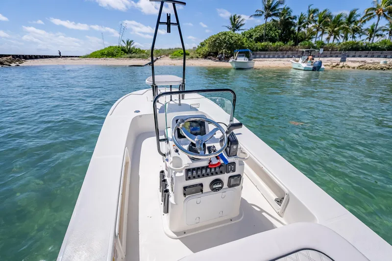 Slide: The Image of 2026 Spyder FX17 Flicker boat navigating clear waters near a tropical shoreline. - 36