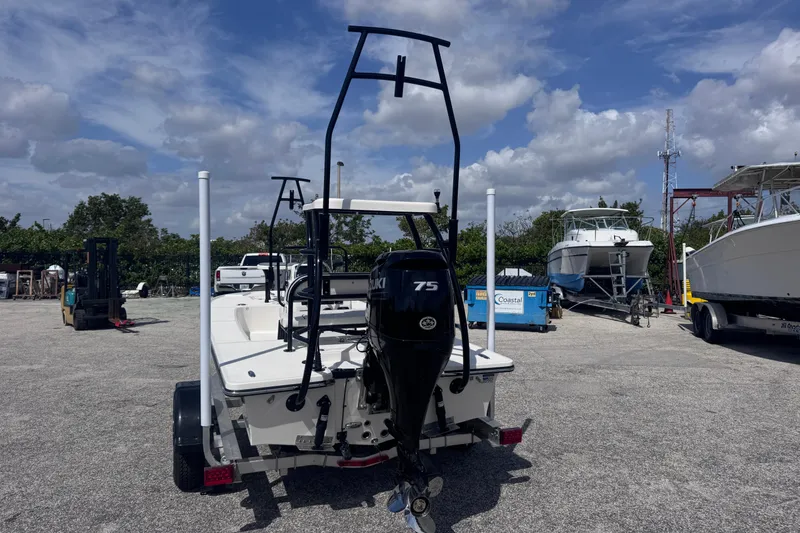 Slide: The Image of 2026 Spyder FX17 Flicker boat with Suzuki 75 engine on trailer, parked outdoors. - 6