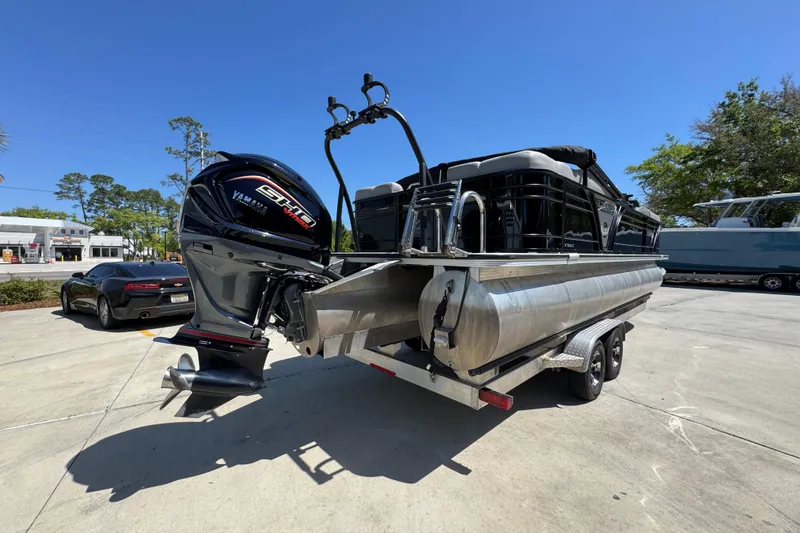Slide: The Image of 2023 Veranda VTX 25RC pontoon boat with Yamaha engine on trailer, parked outdoors. - 12